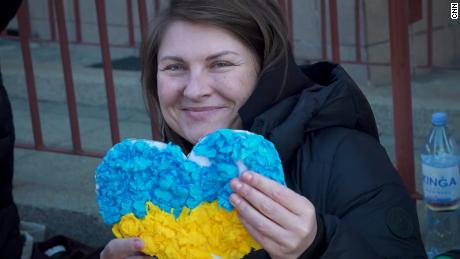 Maria Halligan holds a paper heart made for her by Polish children as she prepares to return to Ukraine.