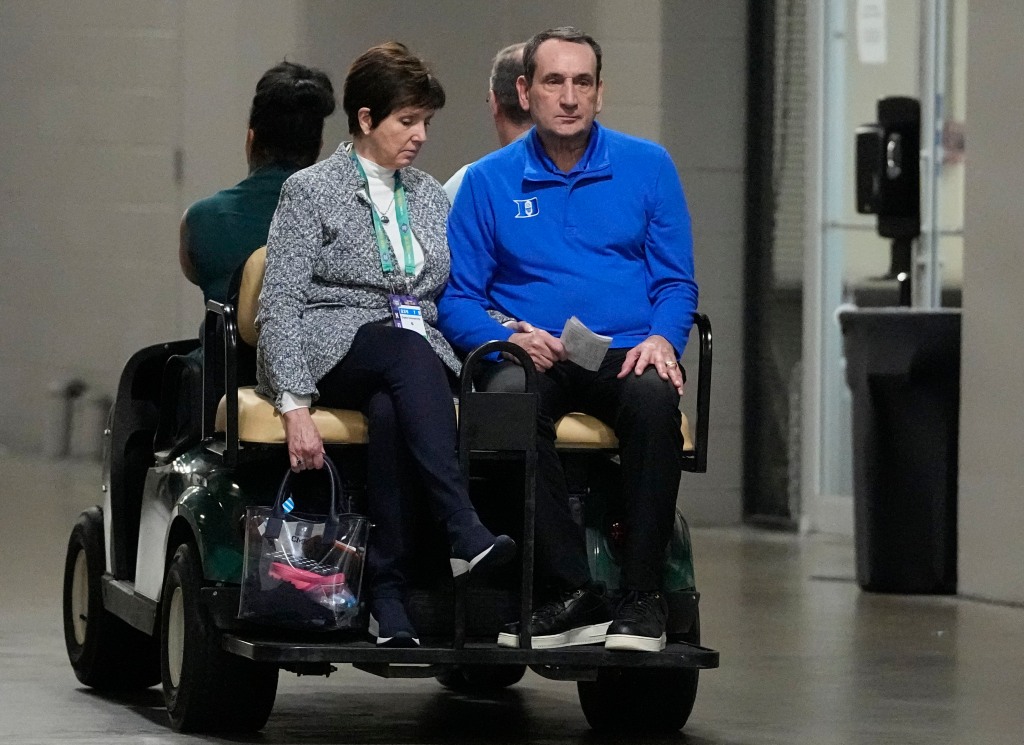 Mike Krzyzewski leaves a press conference with his wife Mickey after the Duke lost 81-77 at the Final Four to North Carolina.  Coach K joked to reporters 