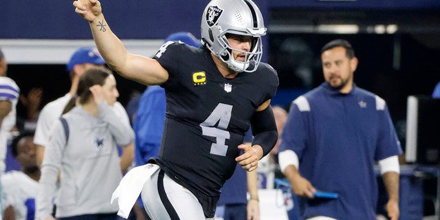 Las Vegas Raiders quarterback Derek Carr celebrates running the ball for the first time in the second half of an NFL football game against the Dallas Cowboys in Arlington, Texas, Thursday, November 25, 2021.