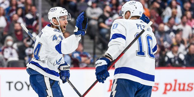 Tampa Bay Lightning defender Yan Ruta (44) celebrates with right winger Corey Perry (10) after scoring a first period goal during the Stanley Cup Finals Game 5 between Tampa Bay Lightning and the Colorado Avalanche at Ball Arena in Denver, Colorado on June 24, 2022.