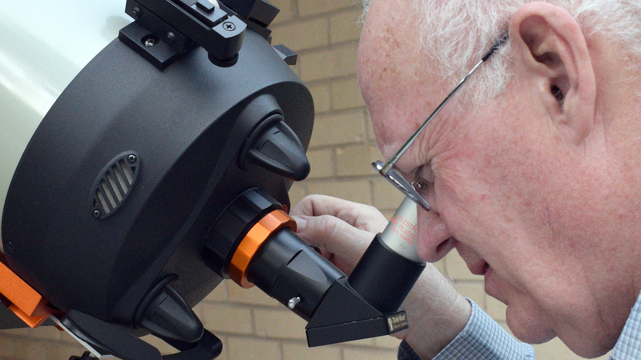 The author looks through the eyepiece on a telescopic celestron