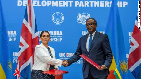 British Home Secretary Priti Patel shakes hands with Rwandan Foreign Minister Vincent Beirutari after signing the partnership agreement at a joint press conference in Kigali, Rwanda, on April 14.
