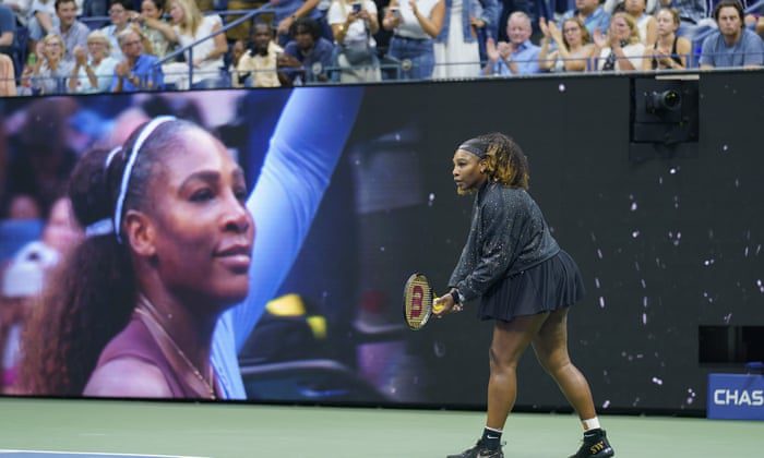 Serena Williams prepares to warm up in front of a large screen welcoming her onto the court.