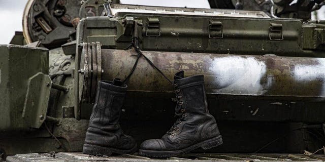 A damaged Russian military vehicle and boots are seen after the withdrawal of Russian forces as the Russo-Ukrainian war continues in Izyum, Kharkiv Oblast, Ukraine on September 14, 2022.