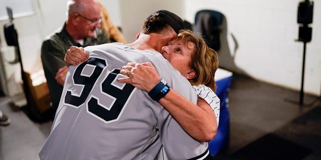 Aaron Judge of the New York Yankees hugs his mother.