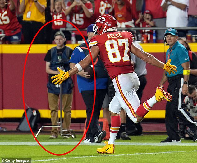 Adams pushed freelance journalist Ryan Zipley (circled), in this photo of Travis Kelsey celebrating the Monday night touchdown in Kansas City.  Zeppelin is seen in the background wearing brown pants and a piece of equipment in his hands