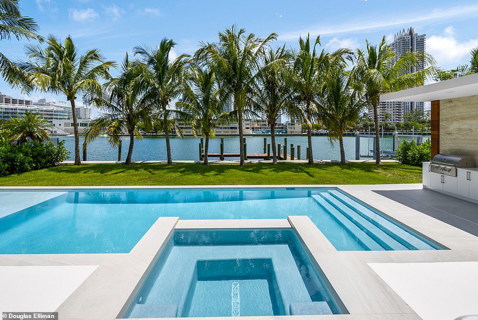 Tropical getaway: There's a large pool and spa in the sprawling palm-lined backyard
