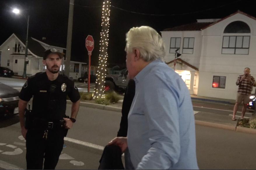 Image of Jay Leno talking with California police officers.