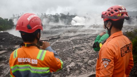 Rescue workers monitor the flow of volcanic material from the eruption of Mount Semeru volcano, in Lumagang, East Java, Indonesia, on December 4, 2022. 