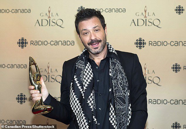 Adam Cohen (above) is also suing Corey.  He is seen above holding.  Award in honor of his father in 2017