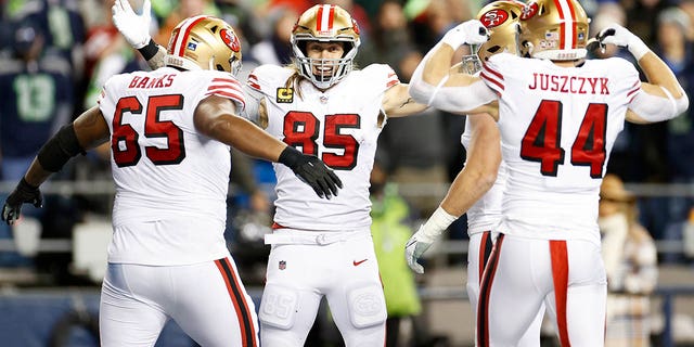 George Kittle #85 of the San Francisco 49ers celebrates with his teammates after scoring a goal against the Seattle Seahawks during the third quarter of a game at Lumen Field on December 15, 2022 in Seattle, Washington. 