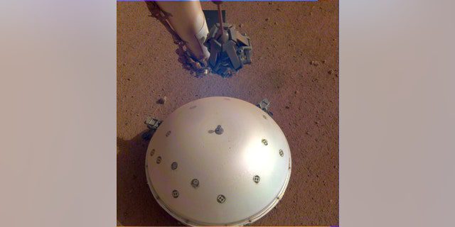 This image shows InSight's domed wind and heat shield covering its seismometer, called the Seismic Experiment of Internal Structure, or SEIS.